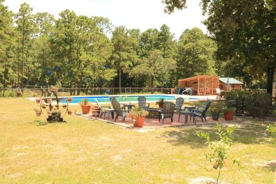 Fire-pit patio and seating beside the in-ground pool