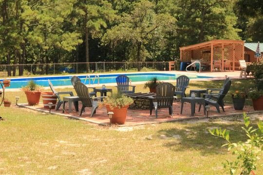 Fire-pit seating next to the pool deck
